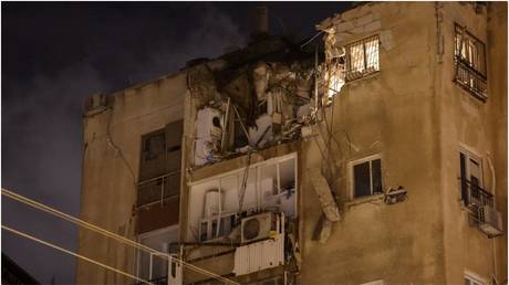 A building in Tel Aviv is damaged by a rocket fired by Palestinian militants from the Gaza Strip on October 7, 2023.