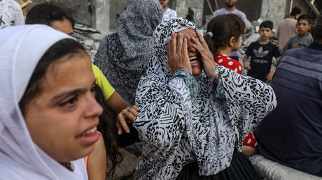 A woman reacts after Israeli fighter jets destroyed a building following the Operation Al-Aqsa Flood launched by Hamas in Rafah, Gaza on October 08, 2023.