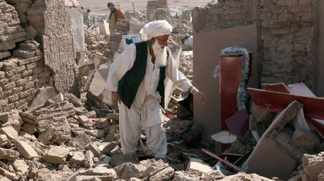 A man cleans up after an earthquake in Zenda Jan district in Herat province, of western Afghanistan, Sunday, Oct. 8, 2023.