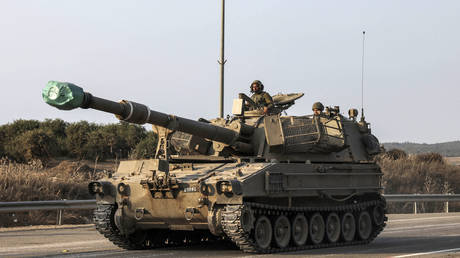 An Israeli self-propelled howitzer rolls on a highway near the southern city of Sderot on October 8, 2023.