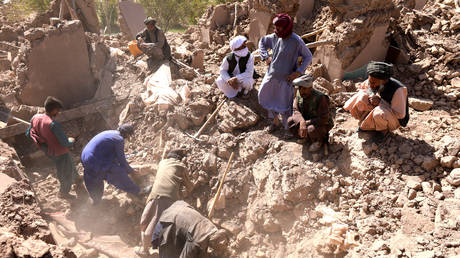 Afghan residents clear debris as they look for victims' bodies in the rubble of damaged houses after the earthquakes in Kashkak village, Zendeh Jan district of Herat province on October 8, 2023.