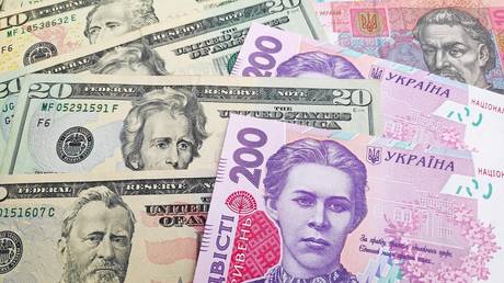 FILE PHOTO: US dollar and Ukrainian hryvnia bills