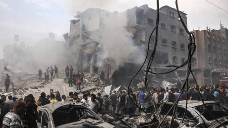 Palestinians search for survivors after an Israeli airstrike on buildings in the refugee camp of Jabalia in the Gaza Strip.