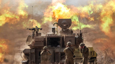 An Israeli army M109 155mm self-propelled howitzer fires rounds near the border with Gaza on October 11, 2023