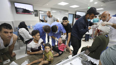 Palestinian children wounded in Israel strikes are brought to Shifa Hospital in Gaza City, Wednesday, Oct. 11, 2023