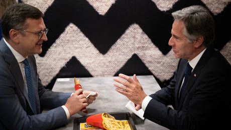 Ukraine's Foreign Minister Dmitry Kuleba and US Secretary of State Antony Blinken speak as they eat at McDonald's in Kiev