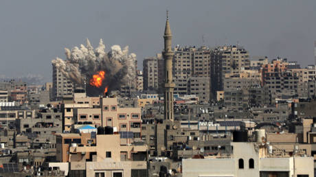 Smoke plumes billow during Israeli air strikes in Gaza City on October 12, 2023.