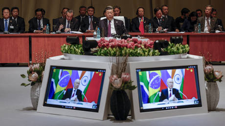  Chinese President Xi Jinping watches Vladimir Putin’s video-address during the 2023 BRICS Summit in Johannesburg.