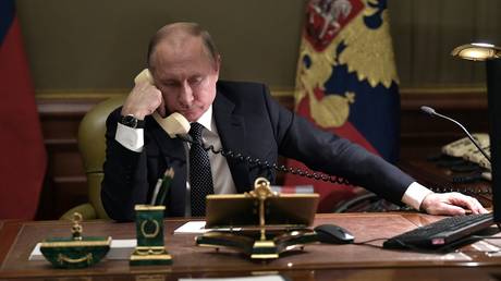 FILE PHOTO. Russian President Vladimir Putin speaks on the phone