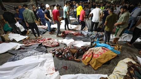 People gather around bodies of Palestinians killed at the al-Ahli Arab hospital in central Gaza, October 17, 2023.