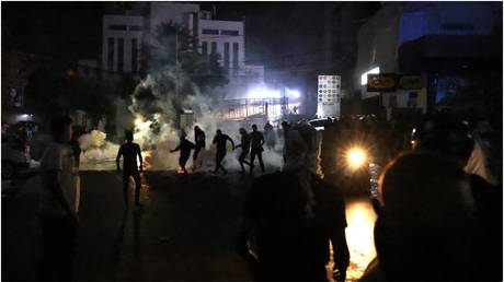 Protesters throw bricks at the US Embassy during a protest in solidarity with the people of Gaza, in the Beirut suburb of Awkar on October 17, 2023.