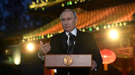 Russian President Vladimir Putin gives a press conference in Beijing