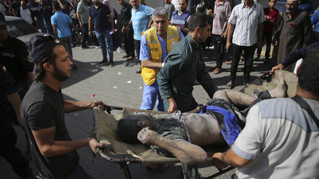 Palestinians bring wounded to the Shifa hospital in Gaza City, October 18, 2023