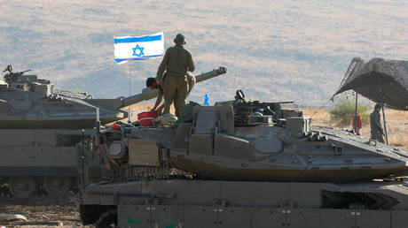 Israeli Merkava tanks are positioned in the north of Israel near the border with Lebanon on October 15, 2023.