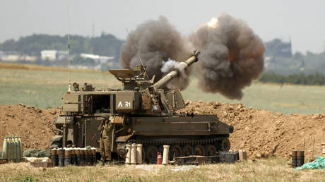 An Israeli 155mm self-propelled howitzer fires artillery shells towards the Gaza Strip.