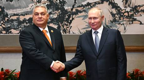 Hungarian Prime Minister Viktor Orban and Russian President Vladimir Putin shake hands before their meeting as part of the 3rd Belt and Road Forum at the Diaoyutai State Guest House in Beijing, China.