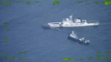 A Philippines supply boat, top left, sails near a Chinese coast guard ship, top right, and a Chinese militia vessel off Second Thomas Shoal, locally called Ayungin Shoal, at the disputed South China Sea on Sunday Oct. 22, 2023.
