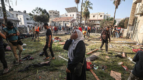 A Palestinian woman cries inside the compound of the Ahli Arab/Baptist Hospital in Gaza City, October 18, 2023.