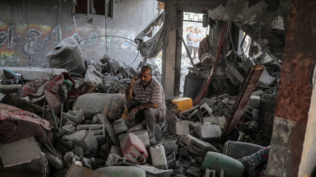 A Palestinian is seen on the debris of destroyed buildings as Israeli airstrikes continue in the 19th day in Khan Yunis, Gaza on October 25, 2023