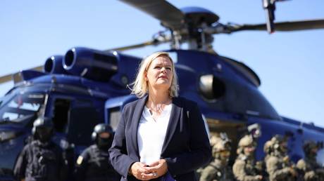 German Interior Minister Nancy Faeser poses in front of members of the GSG 9 federal police special forces unit during a visit to their training center on August 08, 2022 in Sankt Augustin, Germany