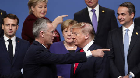 FILE PHOTO: Donald Trump and NATO Secretary-General Jens Stoltenberg speak after a group photo at a NATO leaders meeting in Watford, England, December 4,  2019