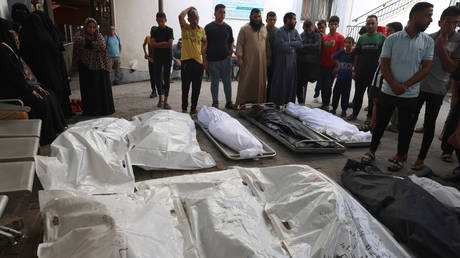 Palestinian relatives wait to collect the bodies of victims at a hospital following an Israeli air strike on Rafah in southern Gaza Strip.