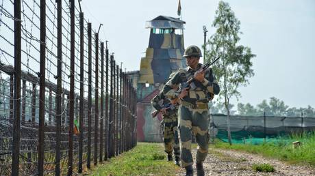 Border Security Force (BSF) personnel patrolling along the barbed wire fence at India-Pakistan border during Independence Day celebrations at RS Pura Sector in Jammu Kashmir on August 14, 2021