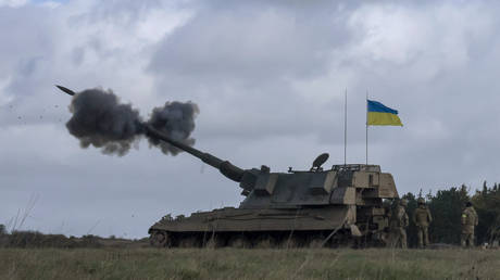 Ukrainian soldiers fire an AS90 self-propelled artillery gun at a training camp in England, March 24, 2023