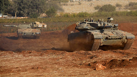 Israeli Merkava tanks take part in a military drill near the border with Lebanon in the upper Galilee region of northern Israel on October 26, 2023.