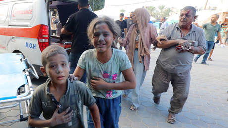 Injured Palestinians, including children, are taken to a Gaza hospital after an Israeli attack on Tuesday in Deir al Balah.