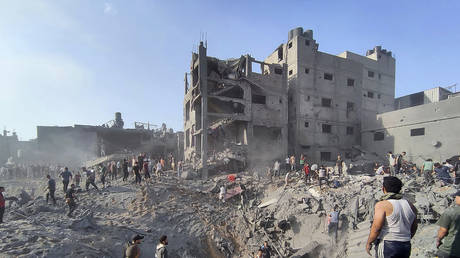 Palestinians inspect buildings destroyed by Israeli airstrikes on the Jabaliya refugee in Gaza, October 31, 2023