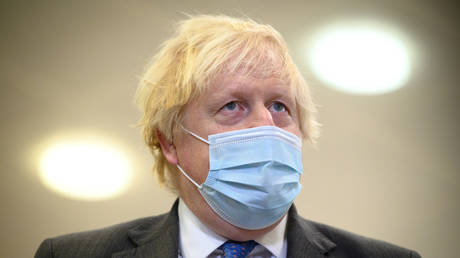 Britain's then-Prime Minister Boris Johnson speaks with the media during a visit to an NHS Covid-19 vaccination centre on December 16, 2021 near Ramsgate, United Kingdom