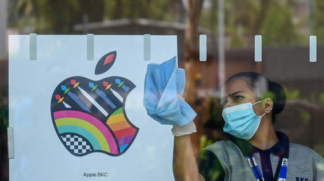 An housekeeping staff works inside the new Apple retail store during a media preview on the eve of its opening in Mumbai on April 17, 2023.