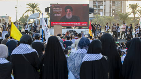 Supporters of the Lebanese movement Hezbollah watch a televised speech by its leader Hassan Nasrallah in Baghdad on November 3, 2023