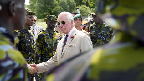 Britain's King Charles III, centre, shakes hands with soldiers during his visit at the Mtongwe Naval Base in Mombasa, Kenya, Thursday, Nov. 2, 2023.