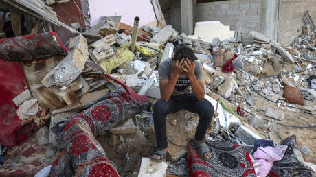 File photo: A Palestinian sits on the rubble of a destroyed home in the Gaza Strip, Octobers 15, 2023.