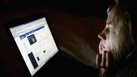 File photo of a young woman browsing the social networking website Facebook