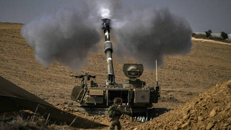 An Israeli army M109 155mm self-propelled howitzer fires rounds toward the Gaza Strip from a position in southern Israel across the border on October 28, 2023.