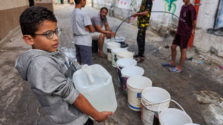 File photo: Children fill up water buckets in an alley in Rafah in the southern Gaza Strip, on November 1, 2023.