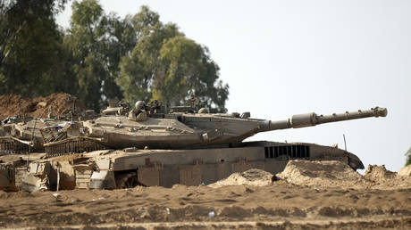 An Israeli tank stands in a staging area near the border with Gaza on November 14, 2023.