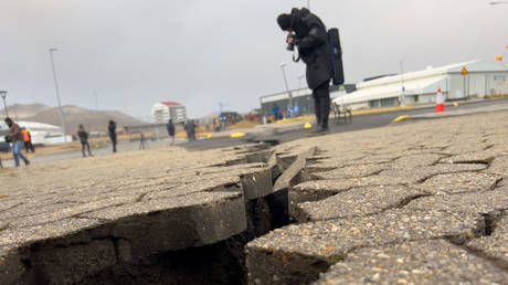 Residents survey damage caused by magma flows and earthquakes under the town of Grindavik, Iceland, on Wednesday.