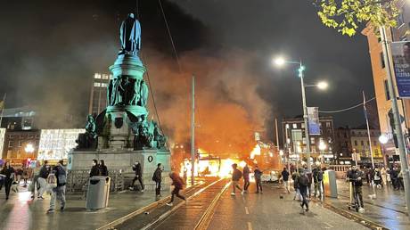 A bus and car on fire after violent scenes unfolded in Dublin city center, Thursday November 23, 2023 following a knife attack