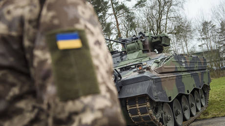 A Ukrainian soldier stands in front of a Marder infantry fighting vehicle during a training session with German troops in Munster, Germany, February 20, 2023