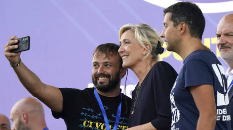 French politician Marine Le Pen takes a selfie with fans after giving a speech at a September event in Pontida, Italy.