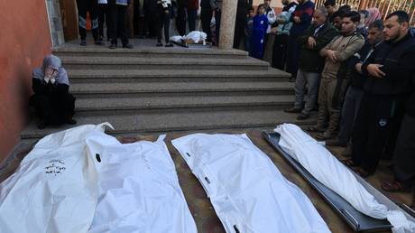 Mourners recite a prayer over the bodies of victims killed Israeli bombing in Khan Yunis in the southern Gaza Strip.