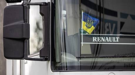FILE PHOTO: A Ukrainian flag is seen behind the windshield of a Ukrainian truck.