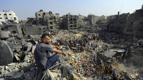 FILE PHOTO. A man sits on the rubble as others wander among debris of buildings that were targeted by Israeli airstrikes in Jabaliya refugee camp, northern Gaza Strip, Wednesday, Nov. 1, 2023.