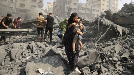 FILE PHOTO. Palestinians evacuate following an Israeli airstrike on the Sousi mosque in Gaza City, October 9, 2023.