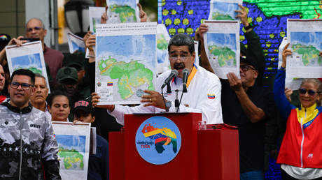 Venezuelan President Nicolas Maduro shows a national map during a march in favor of the Venezuelan position over the disputed territory of Essequibo with the Cooperative Republic of Guyana, in Caracas, Venezuela on December 8, 2023.