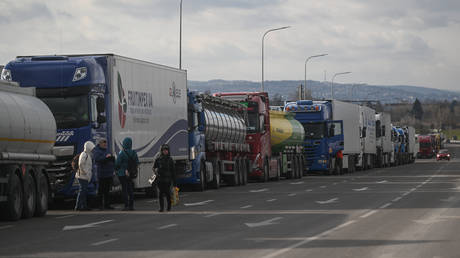  Ukrainian truck wait in a line stretching for kilometers at the Polish-Ukrainian border crossing in Poland.